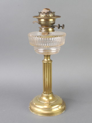 A Victorian circular faceted glass oil lamp reservoir raised on a reeded brass column 42cm h x 15cm d 