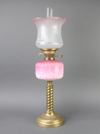 A Victorian opaque pink glass oil lamp reservoir raised on a gilt spiral turned column with later associated glass etched shade and chimney, 68cm h x 18cm diam.