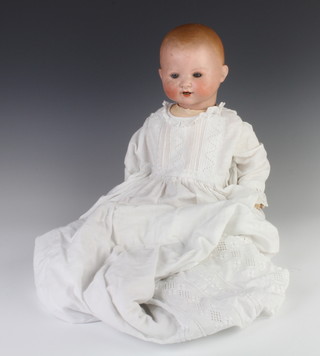 A German porcelain headed doll, head impressed German 241-3 with open eyes and open mouth with 2 teeth 