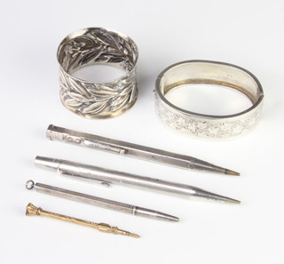 A Victorian repousse silver napkin ring, 3 propelling pencils, a bangle and a gilt toothpick 