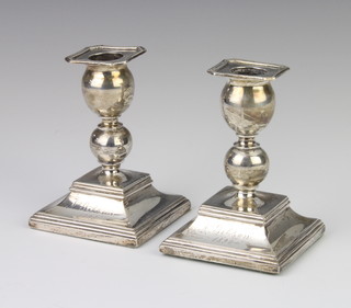 A pair of Russian silver dwarf candlesticks, stamped 84 and with inscription, 11cm 