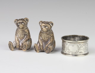 A pair of repousse silver condiments in the form of seated bears, Birmingham 1909 and a napkin ring 50 grams