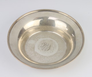 A circular sterling silver dish with monogram 19cm, 140 grams