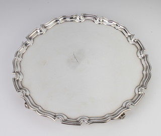 A silver Georgian style salver with Chippendale rim, raised on scroll feet, London 1973, 31cm, 724 grams 