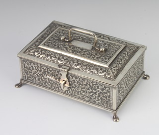 An Indian silver rectangular box chased with flowers on pad feet 17cm, 569 grams