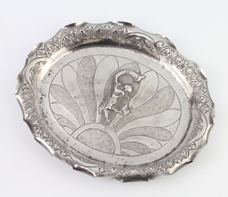 An Indian oval repousse silver dish decorated with a girl blowing a horn 20cm, 138 grams