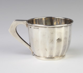 A panelled silver christening mug with angular handle Birmingham 1929, 77 grams
