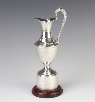 A silver golf trophy in the form of an urn with presentation inscription, raised on a wooden socle 20cm, gross 223 grams