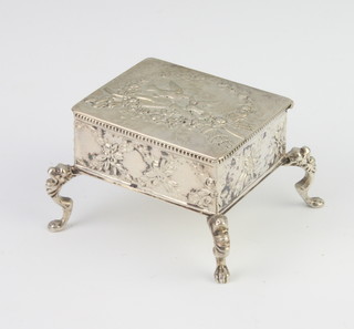 A Dutch repousse silver rectangular box decorated with birds and motifs, raised on scroll feet 55mm 
