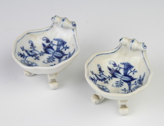 A pair of Meissen shell shaped salts decorated with flowers, raised on scroll feet, 8cm 