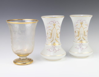 A Bohemian cut glass gilt decorated vase 24cm and a pair of opaline gilt decorated glass vases 25cm 
