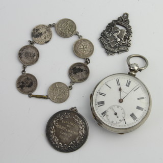 A silver cased keywind pocket watch, 2 fobs and a bracelet 