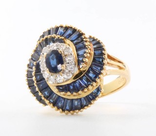 An 18ct yellow gold sapphire and diamond swirl ring, size M