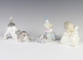 A Lladro figure of a puppy 14cm, a ditto of a seated clown with a puppy on his lap 9cm and a seated angel 8cm 
