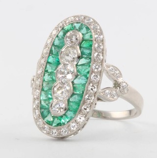 A platinum Art Deco style 5 stone diamond and emerald oval ring, size  N
