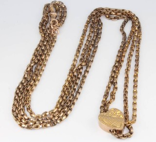 A 9ct yellow gold muff chain with heart runner 26.7 grams