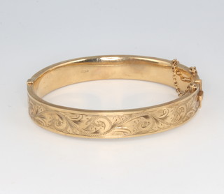 A 9ct yellow gold hollow bangle with engraved decoration 15.3 grams 
