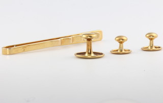 A 9ct yellow gold tie pin, 4.5 grams and a set of three 18ct yellow gold studs, 3 grams