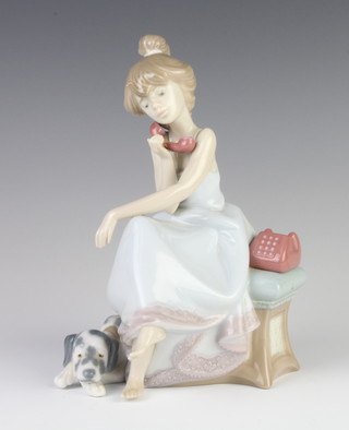A Lladro figure of a young girl on a telephone with a hound at her feet 5466 20cm 