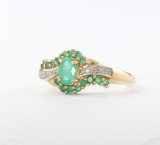 A 9ct yellow gold emerald and diamond dress ring, size P, 3 grams