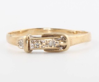 A 9ct yellow gold diamond set buckle ring, size P, 1.3 grams