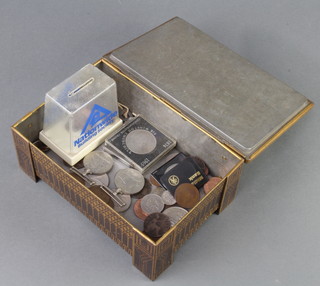 A Huntley and Palmers tin containing a WWII Defence and war medal and a small quantity of UK coinage 