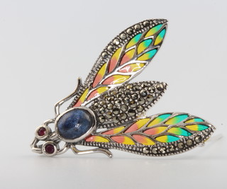 A silver enamel, marcasite and ruby cabochon sapphire bug brooch 
