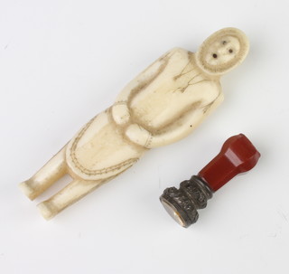 A carved ivory inuit standing figure of a man 9cm together with a hardstone mounted desk seal 