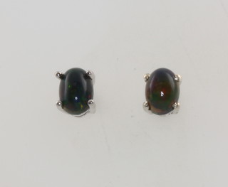 A pair of silver black Ethiopian opal ear studs  