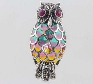 A silver enamel and ruby set owl brooch 