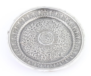 A circular Indian repousse silver dish with floral decoration 19cm, 166 grams