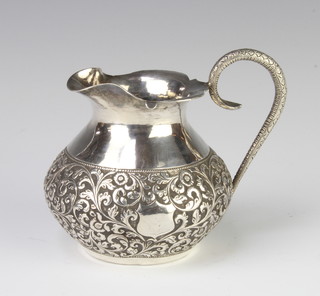 An Indian repousse silver jug with sprawl decoration, 9cm, 126 grams