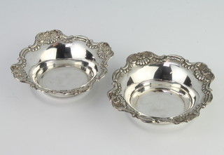 A pair of repousse silver bon bon dishes with floral decoration, 12cm, 104 grams