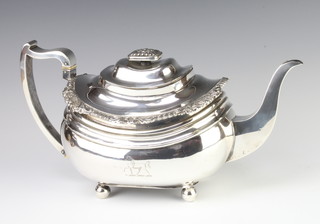 A Georgian silver repousse teapot raised on ball feet, 769 grams