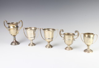 A silver sports trophy, London 1905 and 4 others, 323 grams 