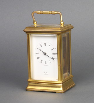 St James, a 20th Century carriage timepiece with enamelled dial and Roman numerals contained in a gilt metal case 