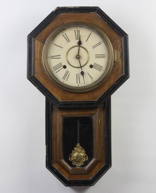 An American 10 day wall clock with paper dial and Roman numerals contained in a pine case with back paper to the drop dial section