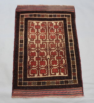 A Belouche brown, red and white ground rug with central field and geometric design within a 3 row border 133cm x 86cm 