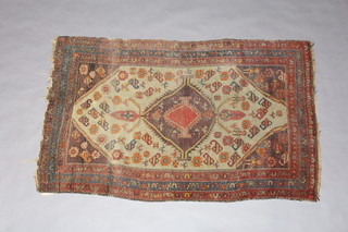 A Caucasian green, red and blue rug with central medallion within a 3 row border 172cm x 106cm 