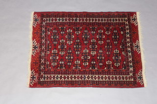 A red and blue ground Belouche rug with stylised octagons to the centre within a multirow border 133cm x 99cm 