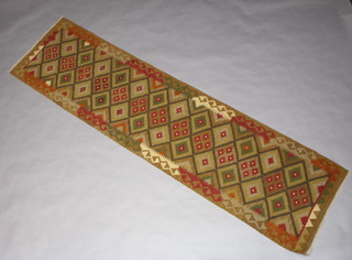 A tan, green and brown ground Maiman Kilim runner with diamonds to the centre 293cm x 80cm 