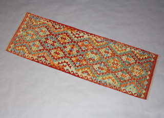 A yellow, brown and green ground Cheli Kilim runner 196cm x 65cm 