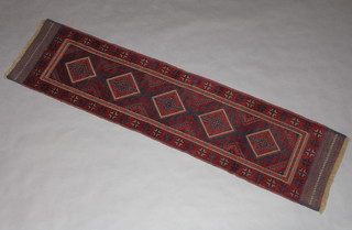 A red and blue ground Meshwani runner with 5 stylised diamonds to the centre within a 3 row border 257cm x 63cm 