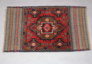 A red and brown ground Belouche rug 137cm x 82cm 