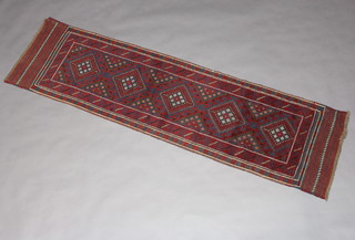 A red and blue ground Meshwani runner with 5 diamonds to the centre in a multi row border 245cm x 62cm 