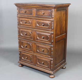 A Jacobean style oak chest of 5 long drawers with geometric mouldings, raised on bun feet 120cm h x 84cm w x 53cm d 