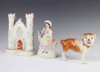 A Staffordshire figure of a Pug dog 13cm, a ditto of a lady with sheep 18cm and a spill vase in the form of a church 23cm 