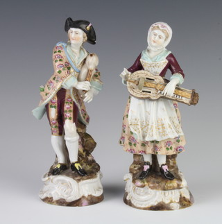 A pair of Volkstadt figures of a lady and gentleman musicians, raised on rococo bases 18cm 