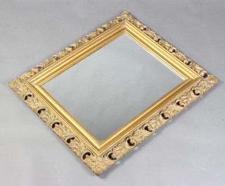 A rectangular plate wall mirror contained in a pierced gilt frame 71cm h x 60cm w 