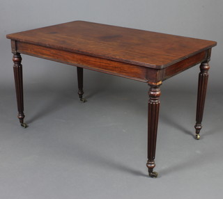A Victorian rectangular mahogany library table, raised on turned and reeded supports ending in brass caps and casters 75cm h x 133cm w x 84cm d 